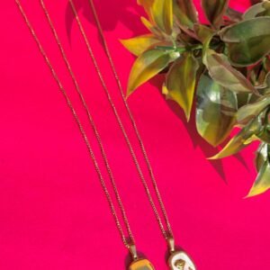 Close-up of Golden Rose Pearl Pendant Necklace showing crystal accent and gold texture